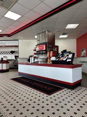 Soda machine and pickup counter; so tidy and clean floors.