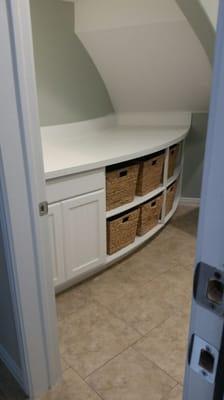 Curved laundry room cabinetry.