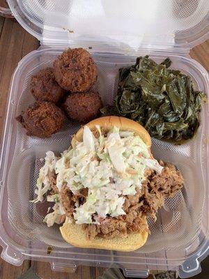 Pulled pork sandwich with coleslaw, collard and hush puppy sides.