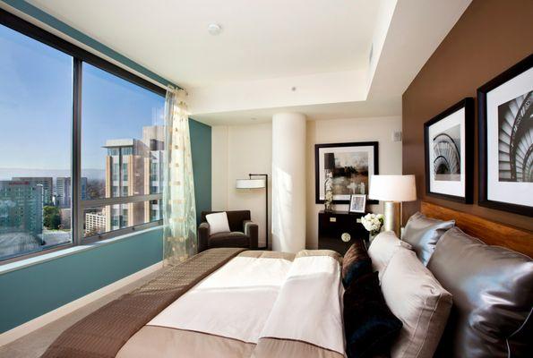 Staged bedroom with over sized windows.