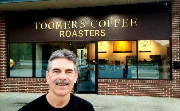 Co-Owner and Roastmaster Sandy Toomer in front of Opelika shop and coffee roastery.