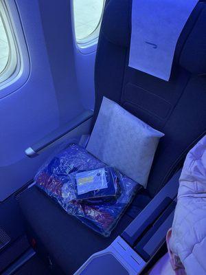 Premium economy: mask, ear plugs, blanket, pillow, lip balm