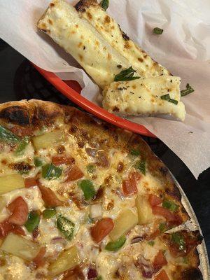 Veggie pizza with cheese bread.