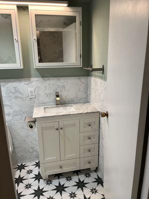 Replaced vanity, new tile, and fresh paint