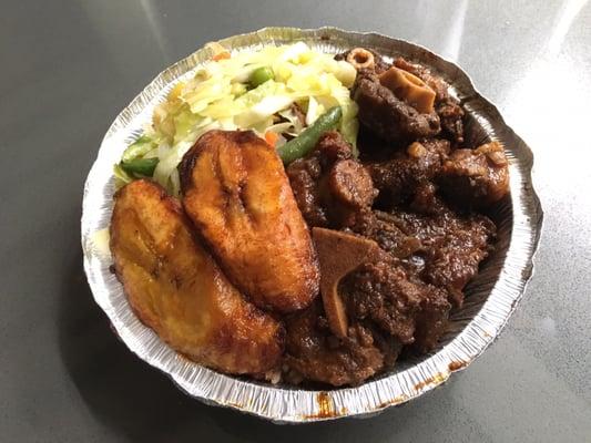 Oxtail, rice and beans, plantains, and steamed vegetables