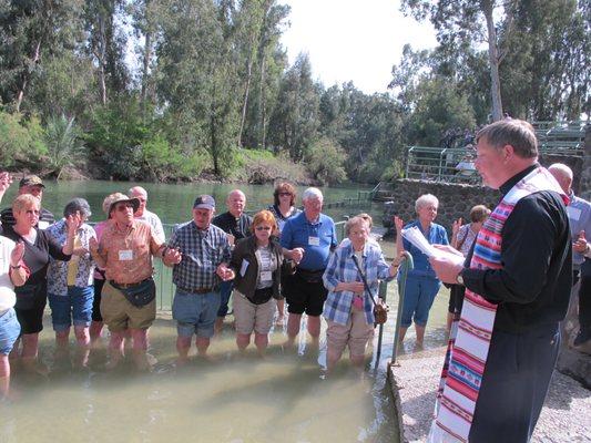 Pilgrims renew their baptismal vows in the Jordan River.