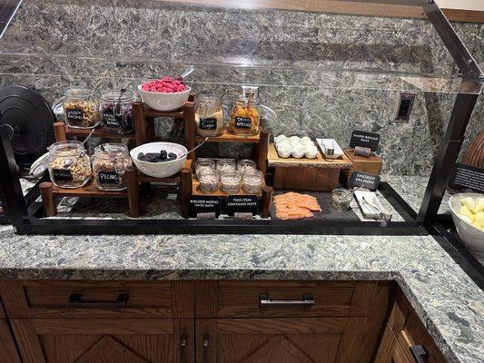 Continental breakfast. Hard boiled eggs, salmon, oatmeal, fruits, and berries for oatmeal.