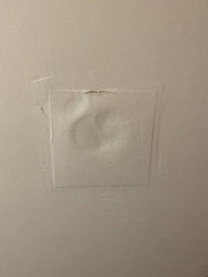 Hole in bathroom door patched improperly patched