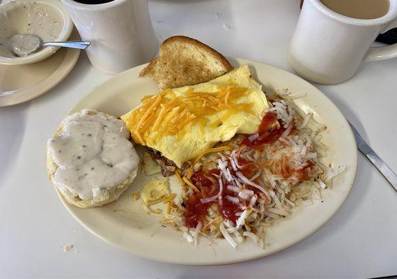 Ham & cheese omelette, hash browns, buttered toast and biscuit with gravy.