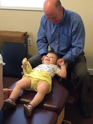 Dr. David working with a young client. She likes to see her Chiropractor.