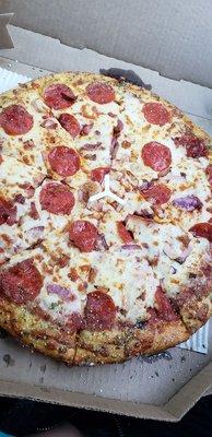 Pepperoni,  bacon & red onion pizza.