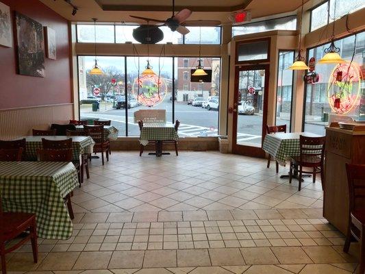 Many tables for eating in after ordering at counter are available in clean, well lit dining area.