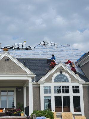 Crew doing a re roof with daVinci shingles