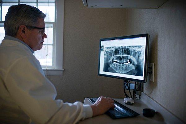 Dr. John reviewing an xray from the SIRONA Panoramic