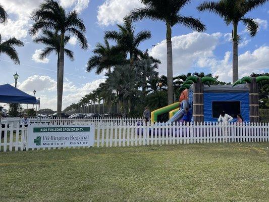 Enclosed play area for children near an "end zone" near the covered tailgate-ish area.