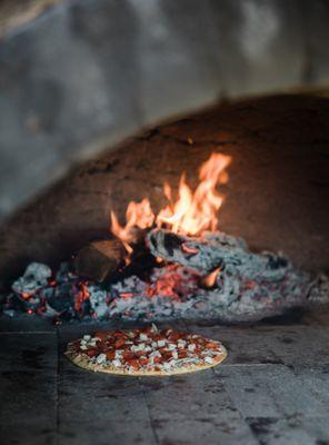 Woof fired pizza out of the vineyard's earth oven