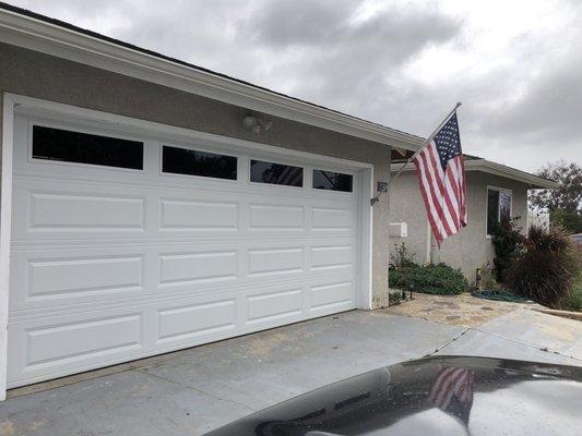 Traditional raised panel C.H.I. garage door with long panel windows.