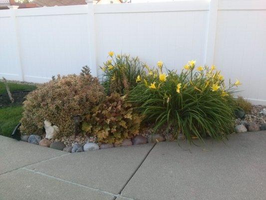 Example of landscaped flowers island with rock landscape.