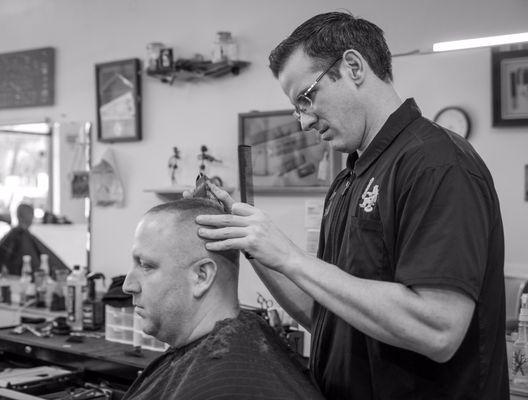 One of our barbers helping a client out.