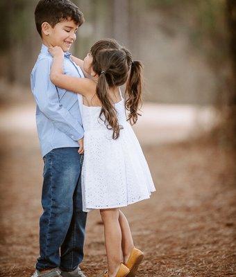 Portrait of brother and sister hugging, super cute