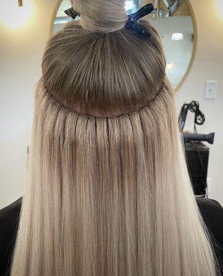 Beaded row extensions and hand-tied wefts.