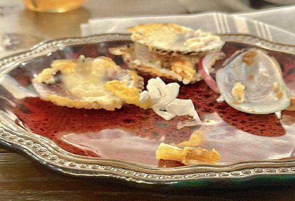 It turned out to be ACTUAL SCALLOP SHELLS filled with OYSTERS covered in Parmesan cheese.