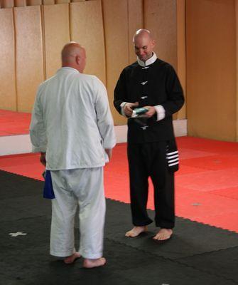 Kung Fu student receiving a new rank after a test.