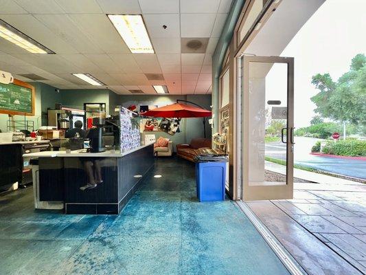 Interior with an outdoor patio umbrella sitting above a clinch.