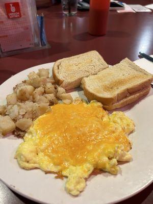 The Scramble-  3 eggs  scrambled with potatoes and toast. I add cheeses!