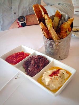 Amuse-bouche: Toasted, seasoned bread + roasted red pepper tapenade, olive tapenade, hummus