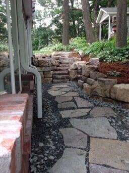 Walkway with limestone boulders leading to a boulder staircase