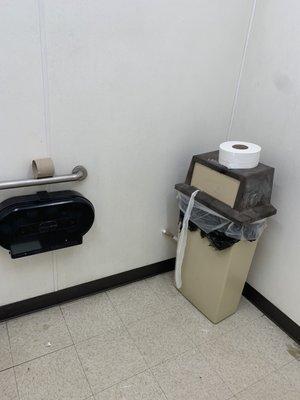 No toilet tissue in the dispenser,it's sitting on top of a garbage can!.