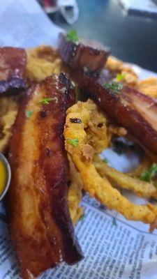 Pork belly on a bed of onion rings with Habeñero BBQ sauce