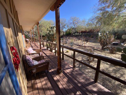 Nice deck and comfy chairs in front of three lower level rooms.