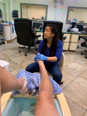 Cathy giving my uncle a hot stone foot massage