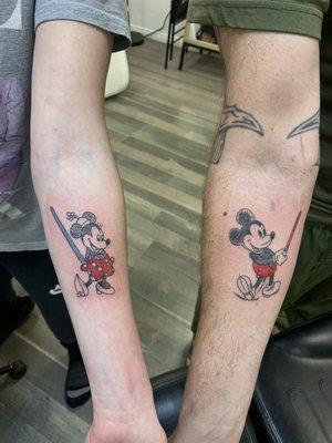 Mickey and Minnie with lightsabers