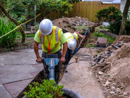 Excavation crew working on adding a sewer line to an ADU