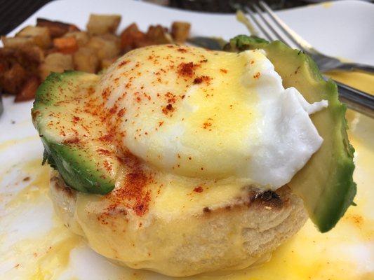 Eggs Benedict with tomato and avocado.  Fresh avocado slices. Perfectly poached eggs.  Not a lot of flavor but good.