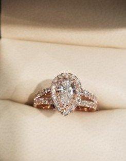 Pear shaped diamond set in a halo style  18 karat rose gold ring.