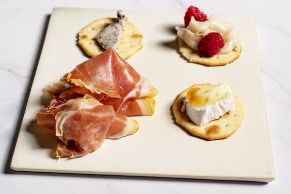 Clockwise from top left: Cabrales, Lardo de Bellota Iberico and raspberries, Camembert topped with Manuka honey (outlier), Jamon Serrano