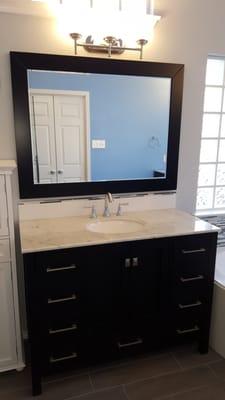 New vanity with custom back splash, new mirror and new lighting.