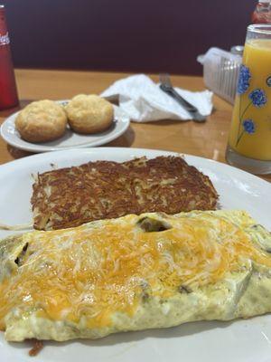 Hashbrowns, cheese omelette with ham and sausage, biscuits, orange juice