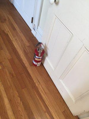 Fire extinguisher used as door stop