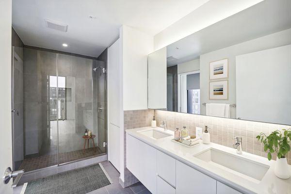 Large bathrooms accompanied by sleek stone finishes