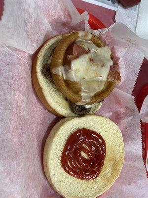 Smashed cowboys burger with pepper jack cheese and onion rings.