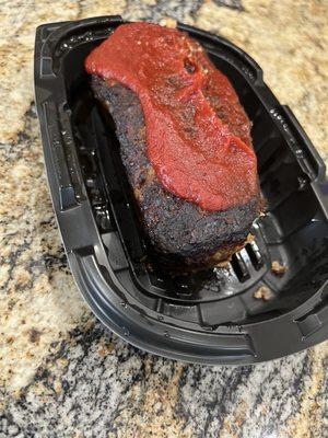 Old burnt meatloaf. Put some more ketchup on it and nobody will notice.