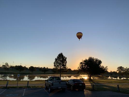 Hot air balloon over the park early on a Sunday