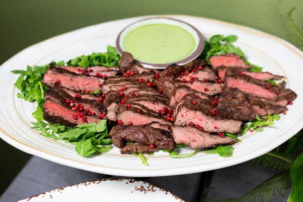 Beef bavette display with green peppercorn sauce