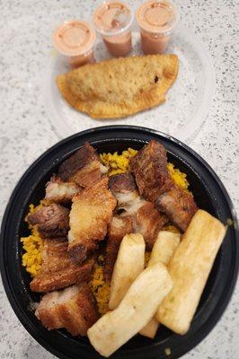 Chicharrón with rice & peas & yuca fries and beef empanada