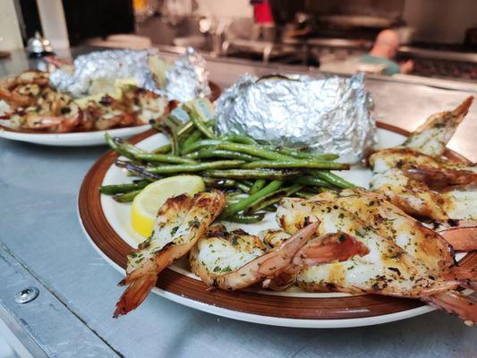 Butterfly shrimp with green beans and baked potato.